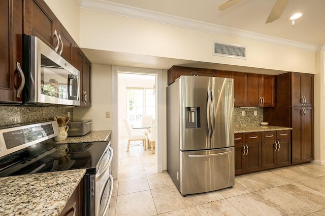 202 Admirals Ln, Key West, FL 33040 - kitchen with appliances with stainless steel finishes, crown molding, tasteful backsplash, light tile patterned flooring, and light stone countertops