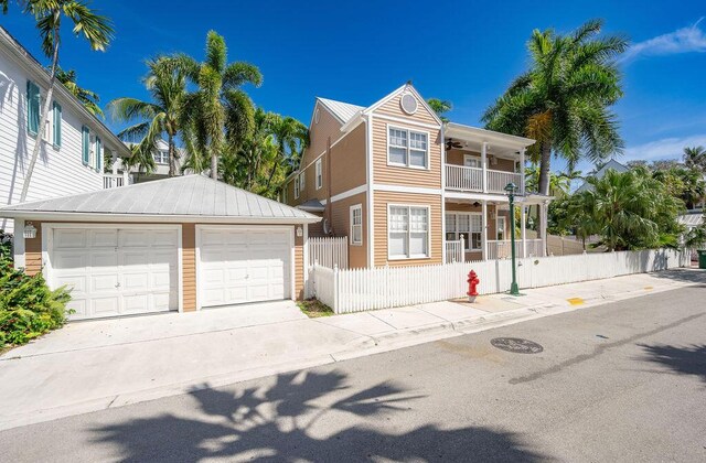 202 Admirals Ln, Key West, FL 33040 - view of front of property with an outdoor structure, ceiling fan, a balcony, and driveway