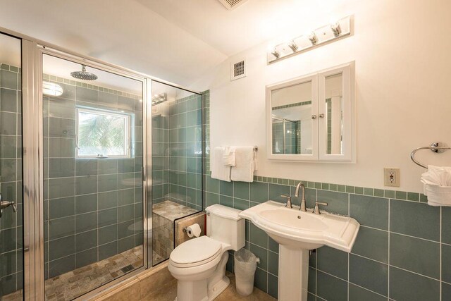 202 Admirals Ln, Key West, FL 33040 - full bathroom with tile walls, a shower stall, toilet, and wainscoting