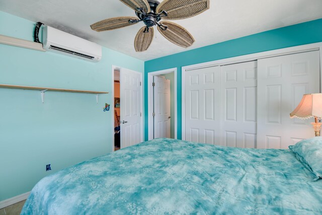 bedroom with ceiling fan, a closet, and an AC wall unit