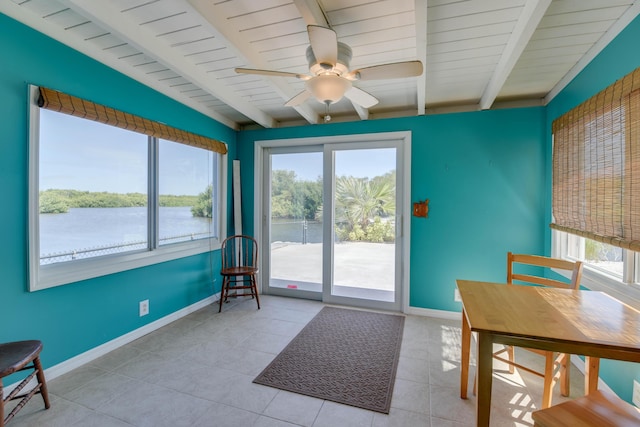 doorway to outside featuring a water view, ceiling fan, beam ceiling, and light tile patterned floors