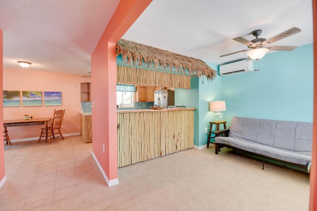 tiled living room featuring a wall mounted AC and ceiling fan