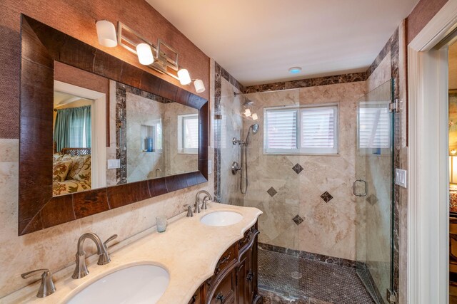 bathroom featuring vanity, plenty of natural light, and a shower with shower door