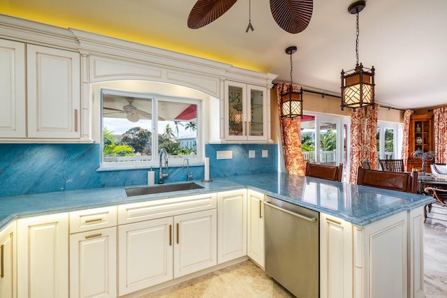 kitchen with hanging light fixtures, sink, stainless steel dishwasher, and kitchen peninsula