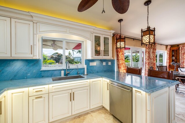 kitchen with decorative backsplash, stainless steel dishwasher, a sink, ceiling fan, and a peninsula