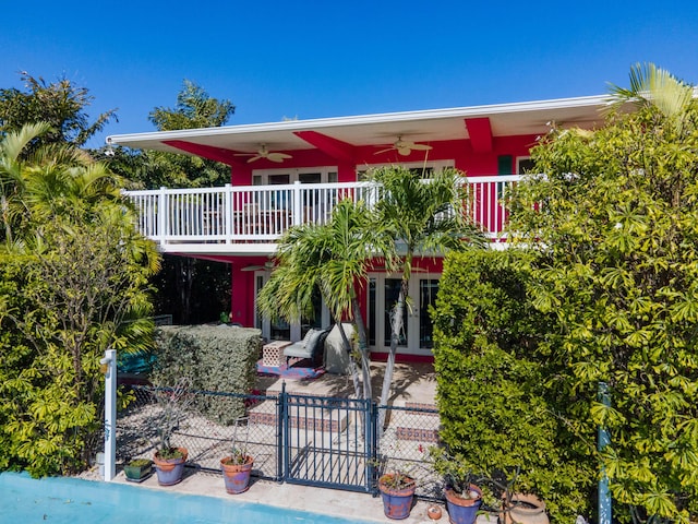 view of front of home with a ceiling fan, a gate, a patio area, and fence