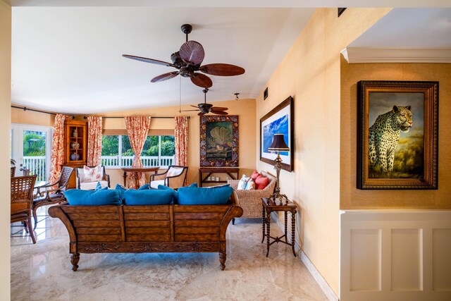 living room with ceiling fan and vaulted ceiling