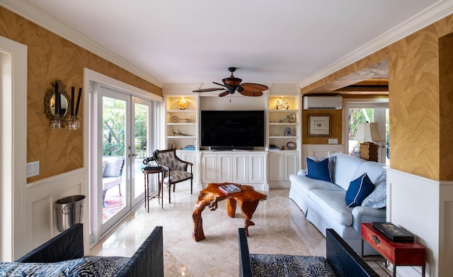 living room with crown molding, built in features, ceiling fan, a wall mounted air conditioner, and french doors