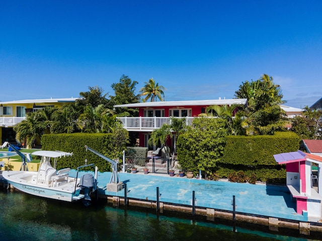 dock area with a water view and a balcony