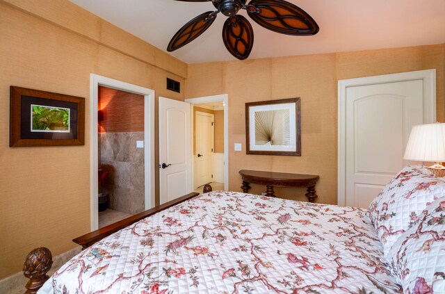 bedroom with wallpapered walls, visible vents, and a ceiling fan