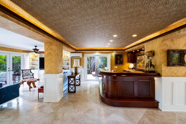 bar with built in features, wainscoting, a wall mounted air conditioner, french doors, and a decorative wall