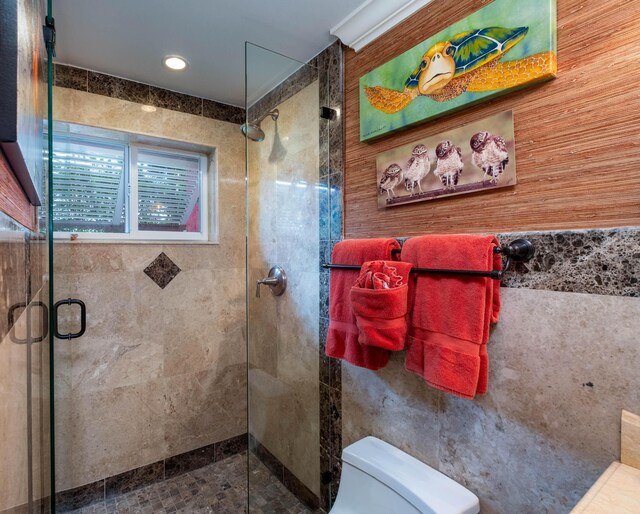 bathroom with a shower with door and toilet