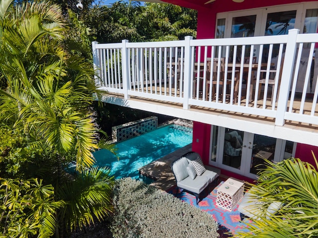 view of patio featuring a balcony, ceiling fan, and french doors