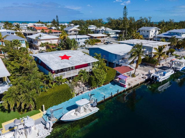 birds eye view of property featuring a water view and a residential view