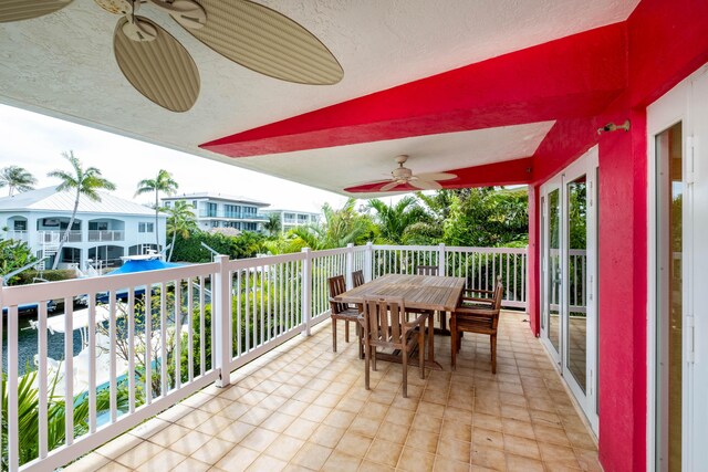 balcony featuring ceiling fan and outdoor dining space