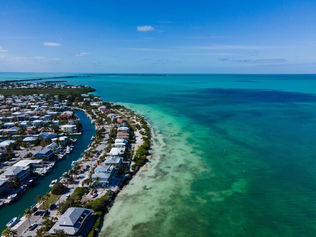 drone / aerial view featuring a water view and a beach view