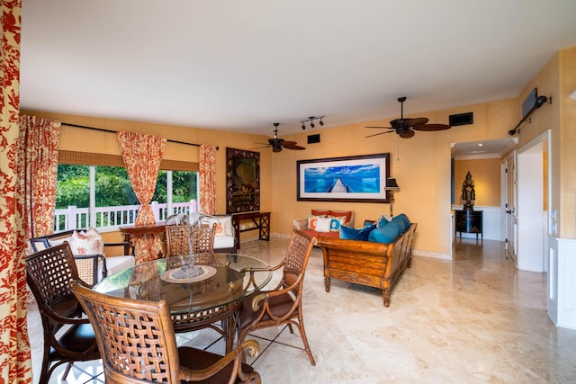 dining space with ceiling fan and track lighting