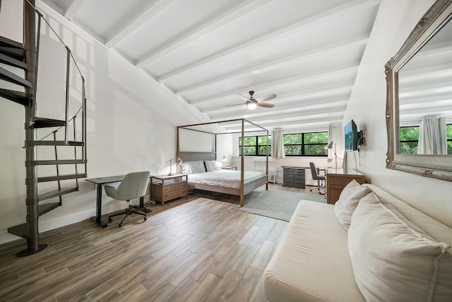 bedroom with lofted ceiling with beams and hardwood / wood-style floors