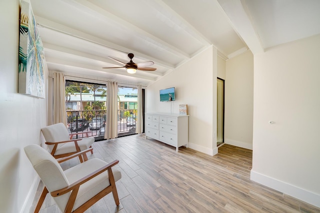 living area with ceiling fan, light hardwood / wood-style floors, and vaulted ceiling with beams