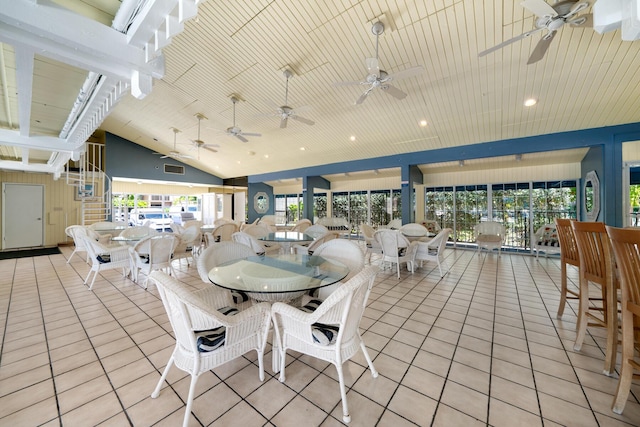 tiled dining area featuring wood ceiling and vaulted ceiling