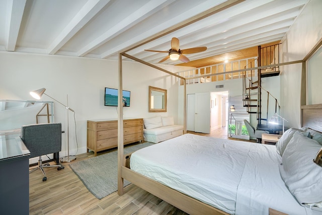 bedroom featuring beamed ceiling and hardwood / wood-style flooring