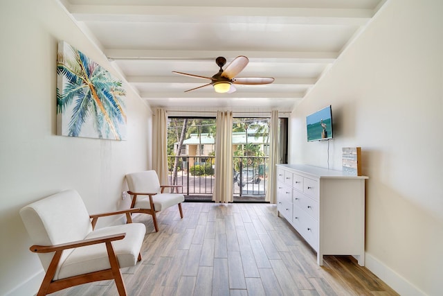 sitting room with beam ceiling, light hardwood / wood-style flooring, and ceiling fan