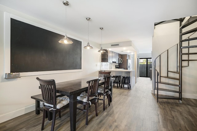 dining space with dark hardwood / wood-style flooring