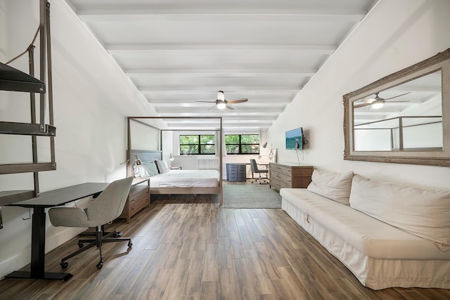 bedroom with hardwood / wood-style flooring, built in desk, and beamed ceiling