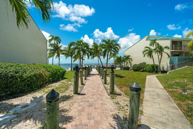 view of home's community featuring a water view and a yard