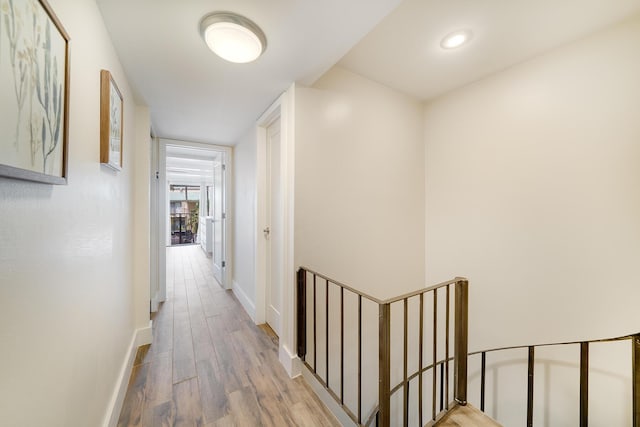 corridor with hardwood / wood-style floors