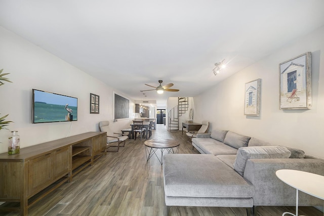 living room with hardwood / wood-style flooring and ceiling fan