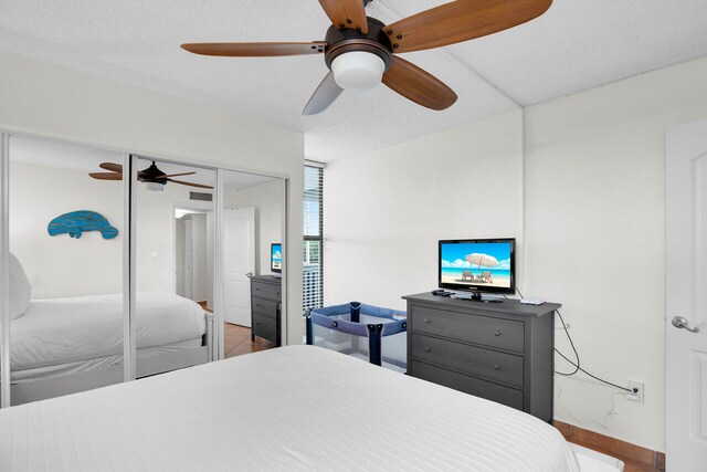 bedroom with ceiling fan, a closet, and a textured ceiling