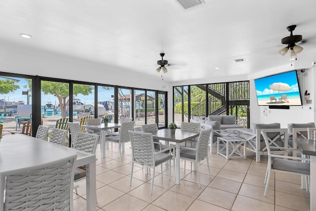 dining room featuring light tile patterned floors and ceiling fan