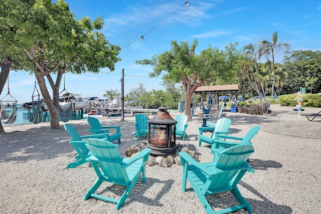 view of patio / terrace featuring a fire pit and a water view