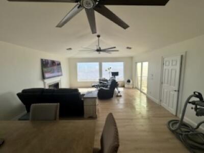 living room with hardwood / wood-style flooring and ceiling fan