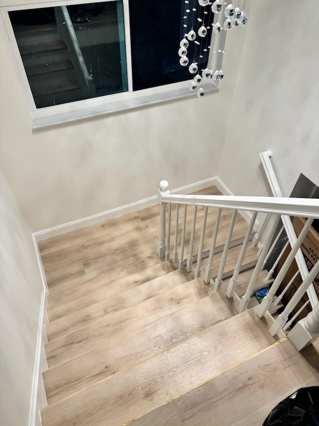 stairs featuring hardwood / wood-style flooring