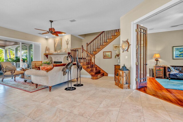 living room featuring light tile patterned floors and ceiling fan