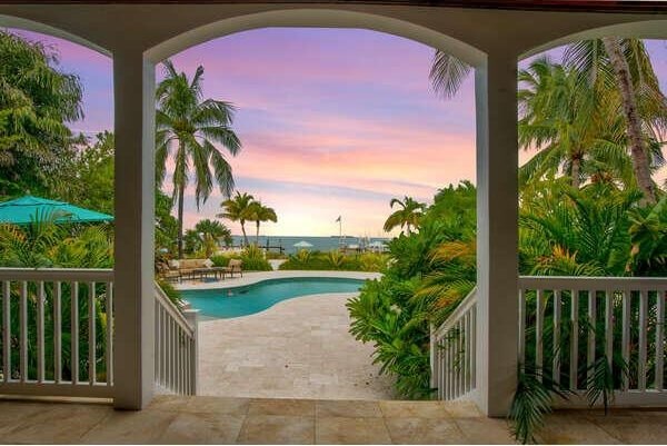 pool at dusk with a patio area