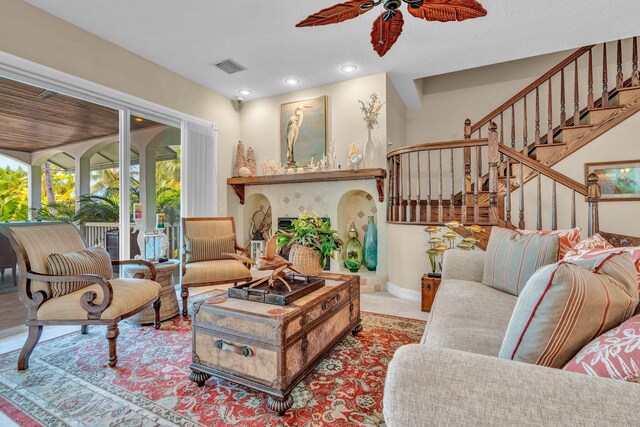 tiled living room featuring ceiling fan