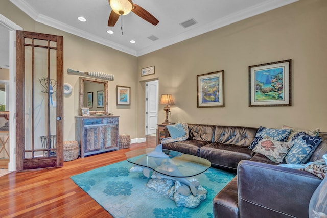 living room with crown molding, hardwood / wood-style floors, and ceiling fan