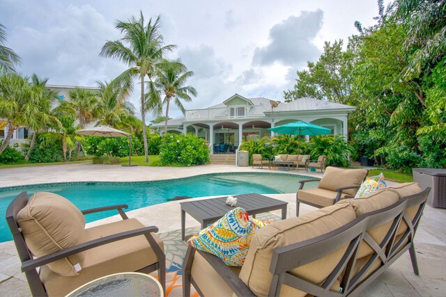 view of pool with an outdoor living space and a patio