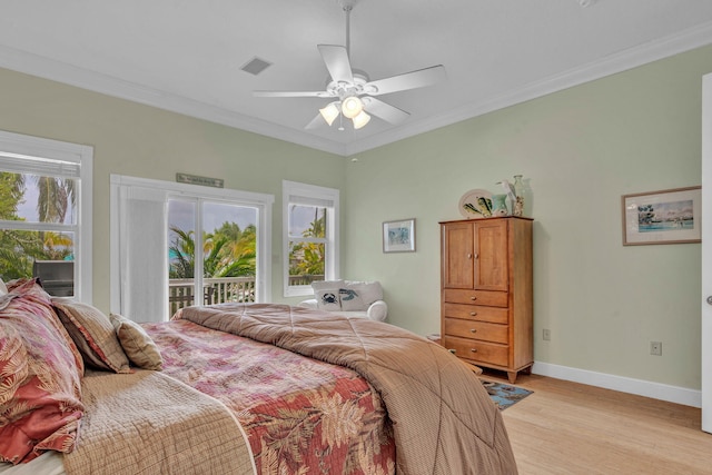 bedroom featuring multiple windows, crown molding, and light hardwood / wood-style flooring