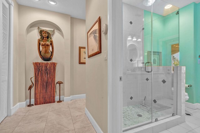 bathroom featuring tile patterned floors and an enclosed shower