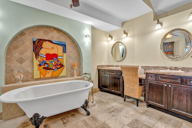 bathroom with vanity, tile walls, and a tub to relax in