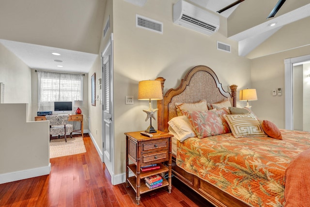 bedroom featuring a towering ceiling, a wall mounted air conditioner, and dark hardwood / wood-style floors