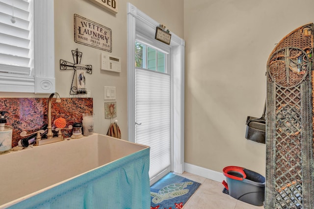 interior space with sink and light tile patterned floors