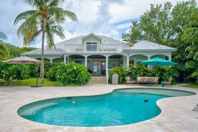 view of swimming pool with an outdoor living space and a patio