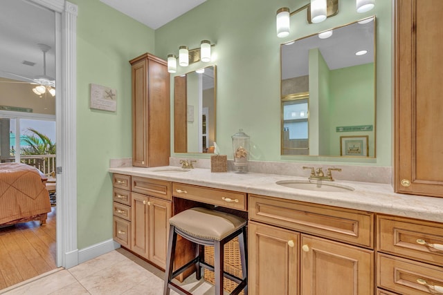 bathroom featuring ceiling fan, tile patterned floors, an enclosed shower, and vanity