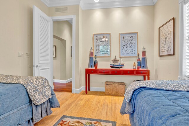 bedroom featuring hardwood / wood-style flooring and ornamental molding