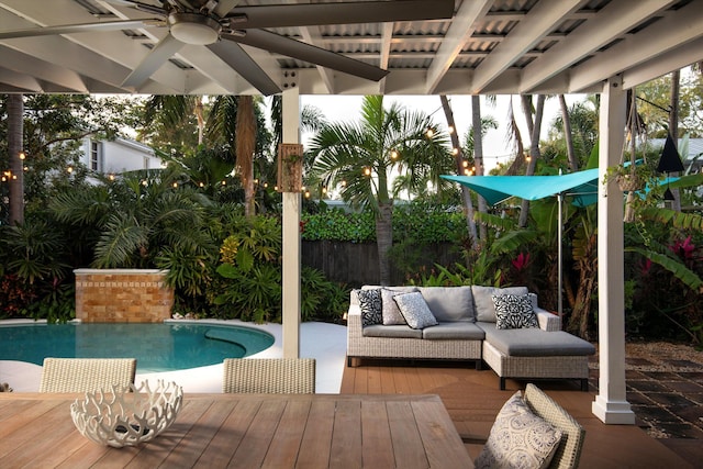 view of pool with an outdoor living space and ceiling fan